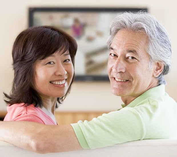 Older couple smiling together in a home setting