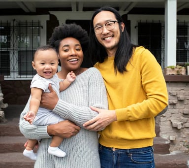 Happy family with baby posing outdoors