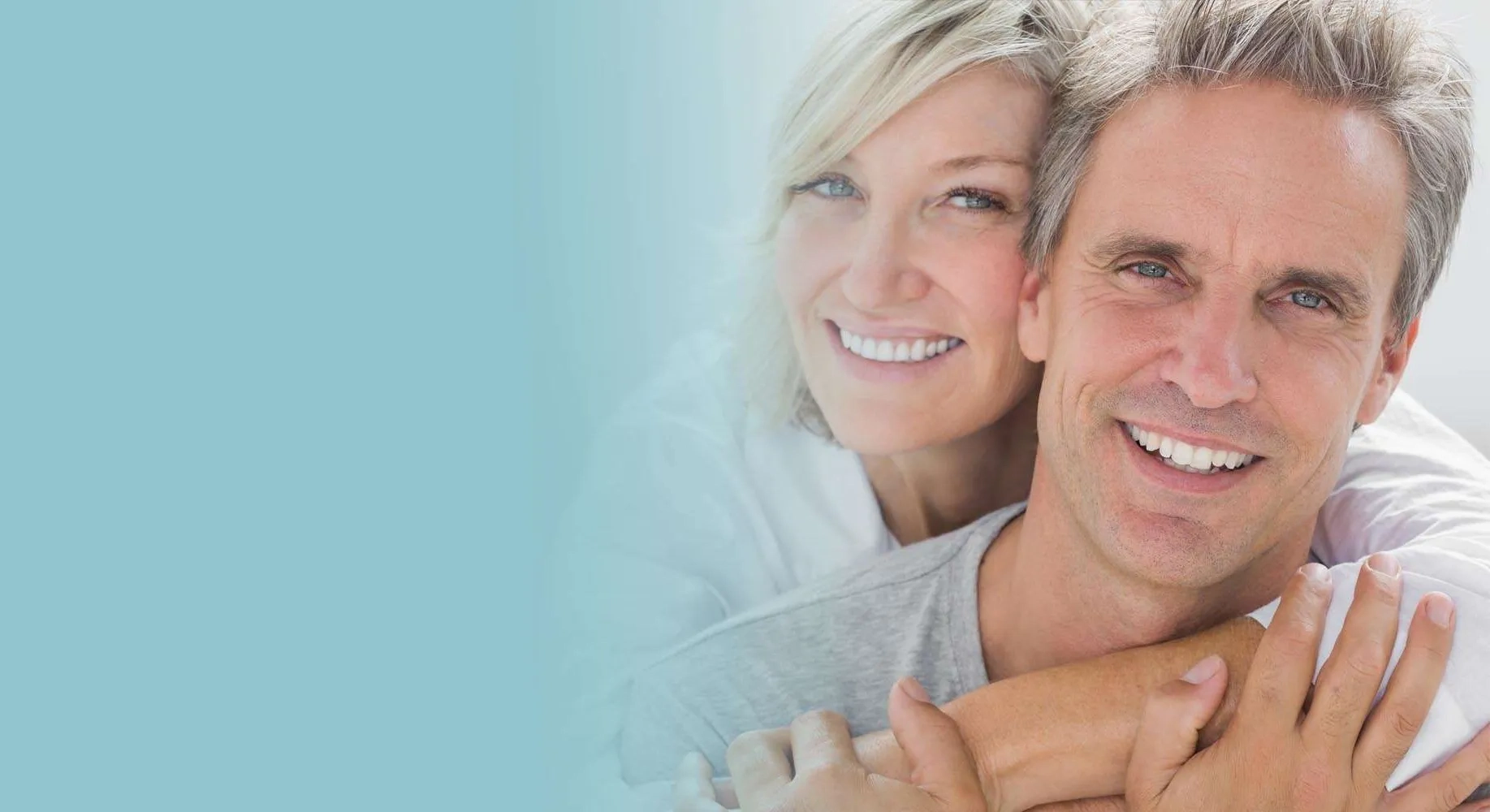 Smiling couple embracing with soft background