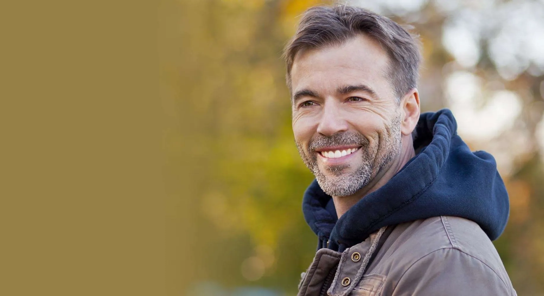 Smiling man in casual jacket outdoors